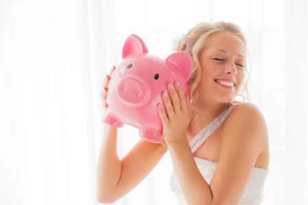 Bride with piggy bank being sillyの写真素材