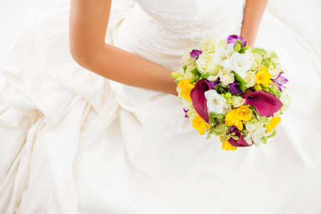 Female in white wedding dress holding flowersの写真素材