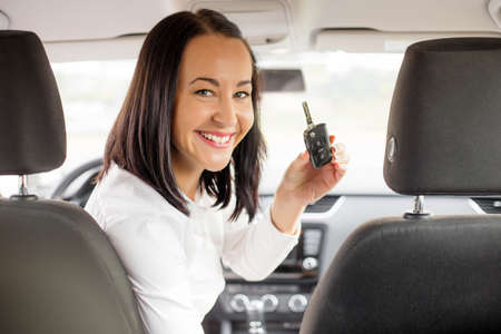 Woman in the vehicle showing car keysの写真素材