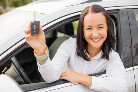 Woman holding her new car keysの写真素材
