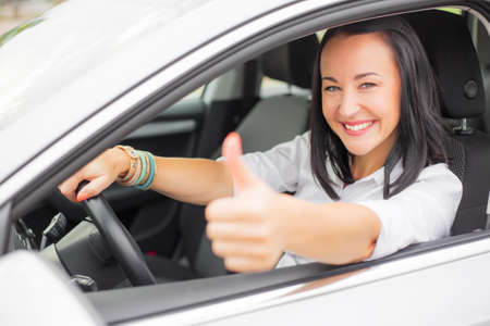 Female driver showing thumbs upの写真素材