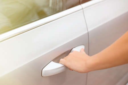 Woman holding cars door handleの写真素材