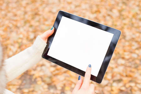 Woman using tablet outdoorsの写真素材