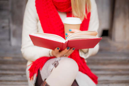 Woman sitting outside and readingの写真素材