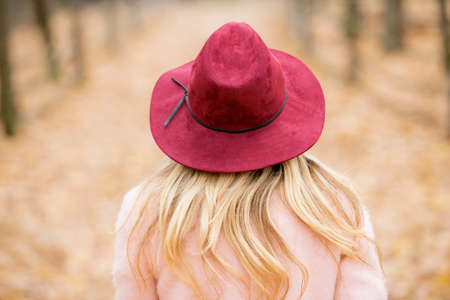 Woman in red hat walking in the parkの写真素材