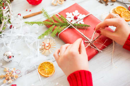 Woman wrapping up Christmas presentsの写真素材