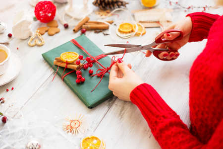 Creative woman wrapping up giftの写真素材