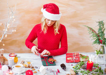 Woman wrapping gifts for Christmasの写真素材