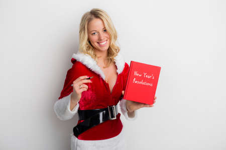 Woman holding New Year's resolution bookの写真素材