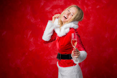 Happy woman celebrating holidays with champagneの写真素材