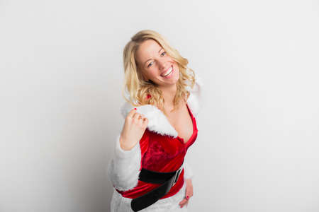 Happy woman dressed in sexy red Santa Claus costumeの写真素材