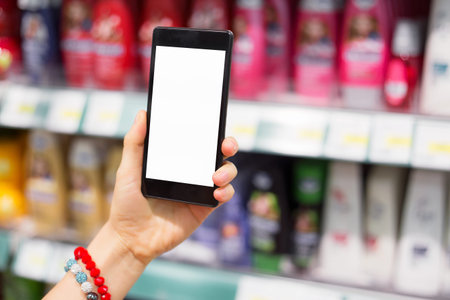 Woman using her smartphone in supermarket