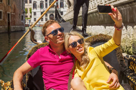 Happy couple taking selfie in gondolaの写真素材