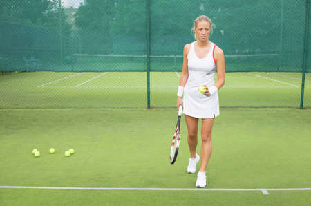 Woman practicing tennisの写真素材