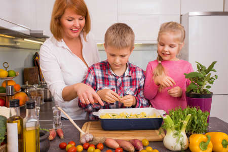 Family having fun cooking in kitchenの写真素材