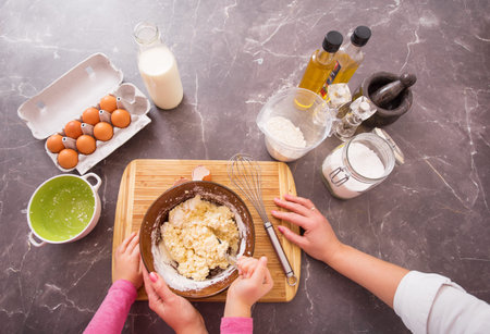 women and child making cookie dough