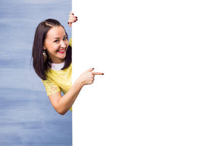 Woman pointing at white backgroundの写真素材