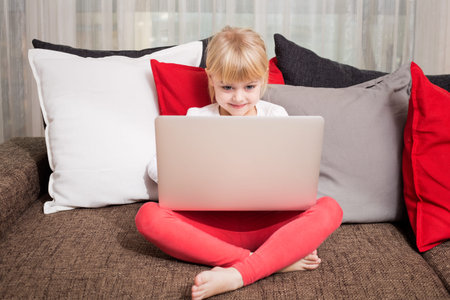 Little girl watching something in computer