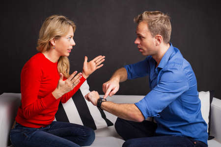 Man and woman having an argument about being lateの写真素材