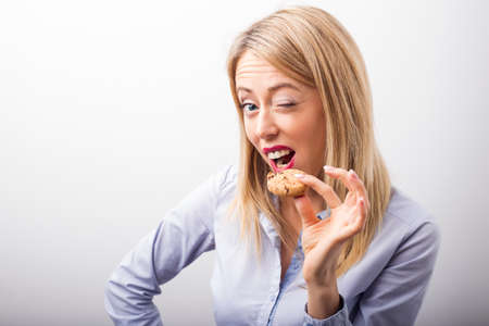 Woman eating  chocolate chip cookieの写真素材
