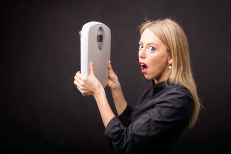 Woman saw her weight on scaleの写真素材
