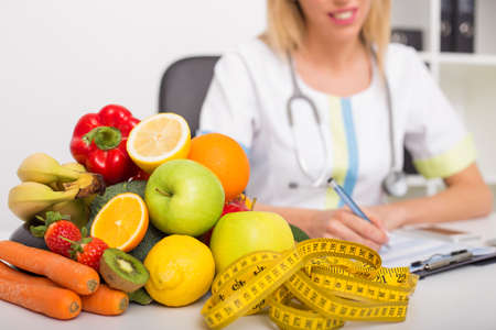 Health coach office with vegetables and tape measureの写真素材