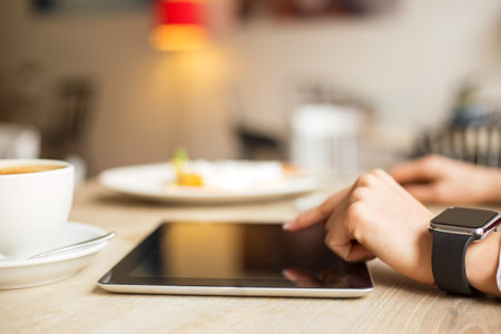 Businesswoman using tablet in cafe