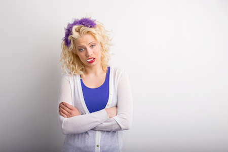 Funny woman with crossed hands standing and showing attitudeの写真素材