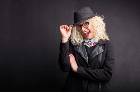 Funny woman holding her hat and flirtingの写真素材