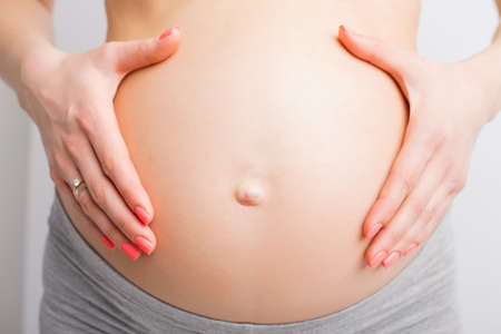 Pregnant woman holding baby bumpの写真素材