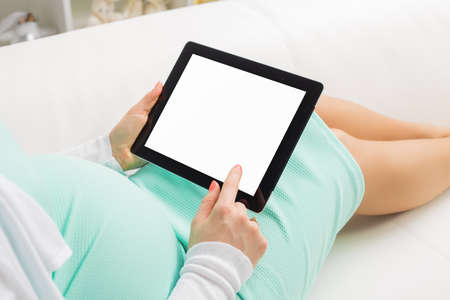 Pregnant woman using blank screen tabletの写真素材