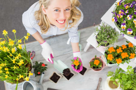 Woman doing gardening in studio setupの写真素材