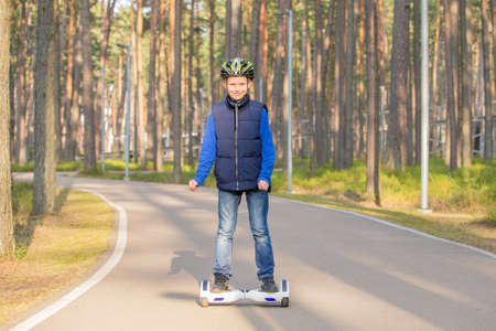 Boy in park using hoverboardの写真素材