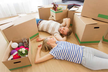 Happy couple moving into new apartmentの写真素材