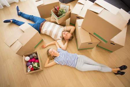 Couple lying on the floor in their new apartmentの写真素材