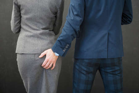 Co-worker touching woman's buttの写真素材