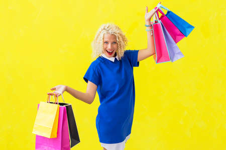 Excited woman with shopping bags being happyの写真素材