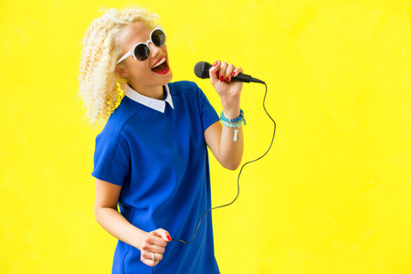 Woman singing and using microphone