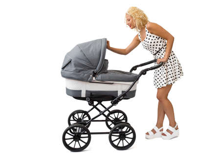 Mother looking into the baby carriageの写真素材