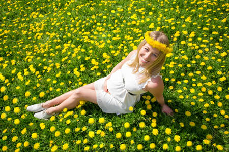 Woman sitting in the meadowの写真素材