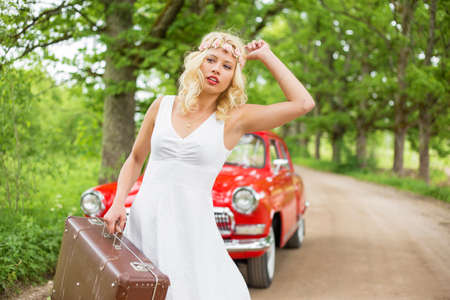 Woman with broken car waiting for helpの写真素材