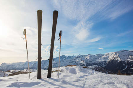 Skis in mountains against blue skyの写真素材