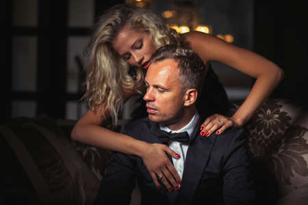 Woman touching man in tuxedoの写真素材
