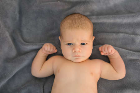 Baby showing his musclesの写真素材