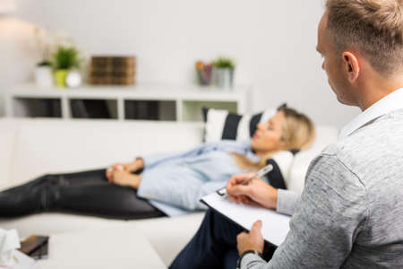Woman lying on couch at doctors officeの写真素材