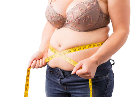 Woman measuring her fat bellyの写真素材