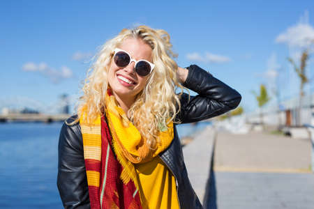 Happy woman sitting outside and smilingの写真素材