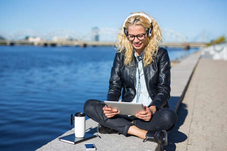 Woman with headphones using tabletの写真素材