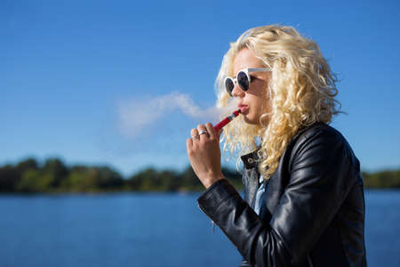 Woman smoking electronic cigaretteの写真素材