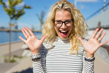 Funny hipster showing her surpriseの写真素材